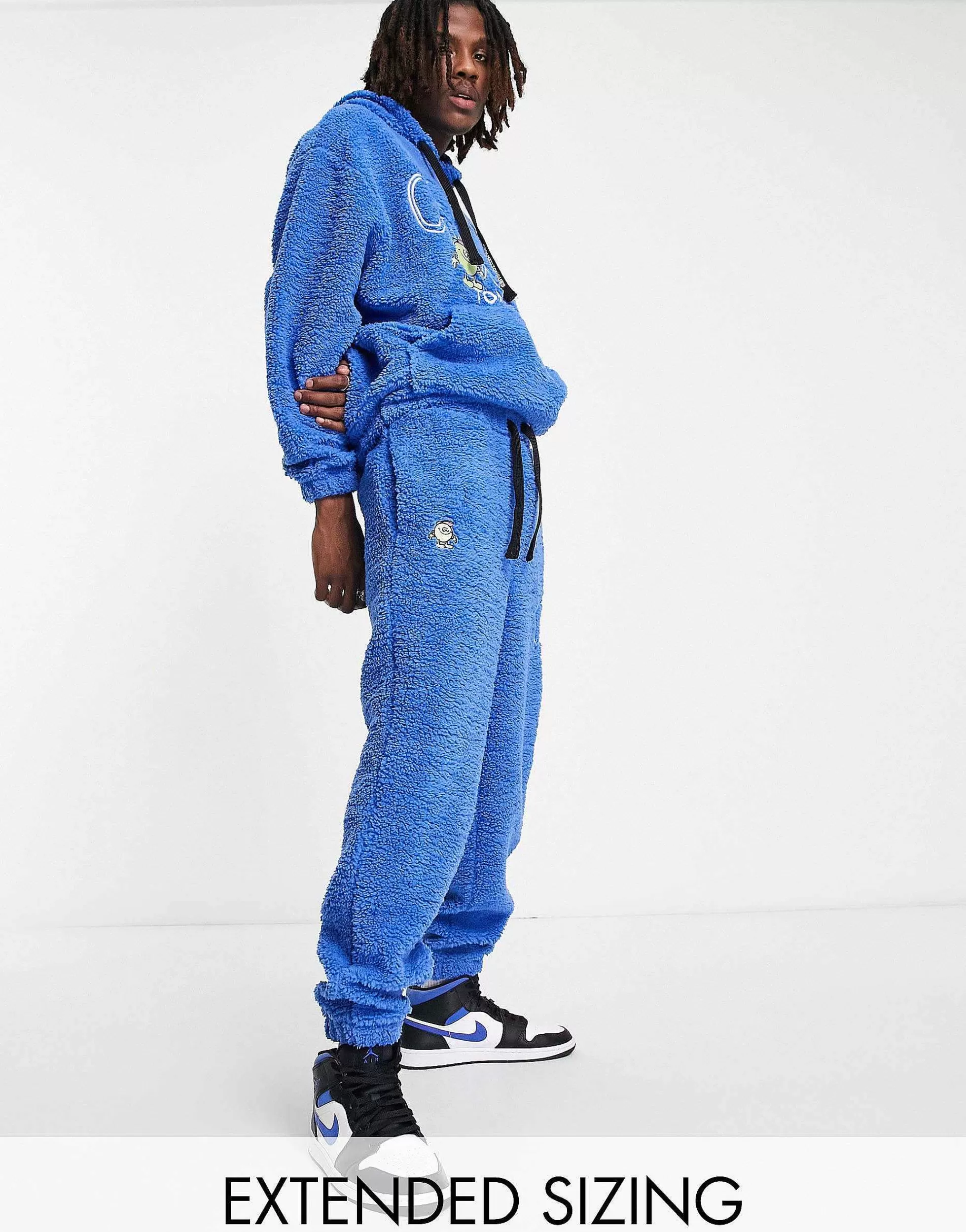 Men Crooked Tongues Co-Ord In Teddy Borg With Logo And Character Embroidery In Blue